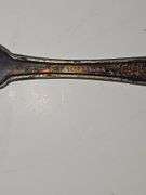 Silver colored cup and flatware