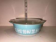Vintage Pyrex Amish Butterprint turquoise with white design casserole dish with a lid.