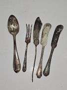 Silver colored cup and flatware