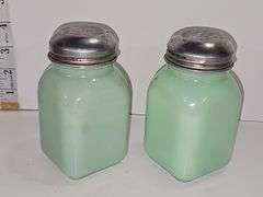 Vintage jadeite pepper shaker with a Scottish Terrier design.