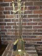 Golden colored fireplace tool set with stand
