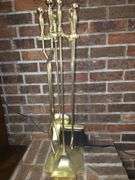 Golden colored fireplace tool set with stand