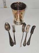 Silver colored cup and flatware
