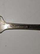 Silver colored cup and flatware