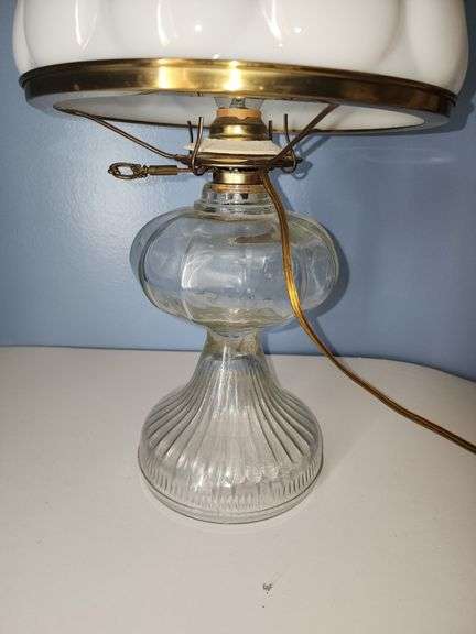 Vintage oil lamp witg milk glass lamp shade with a ruffled edge.
