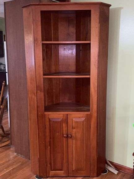 Wooden corner cabinet with display shelves and a lower storage cupboard