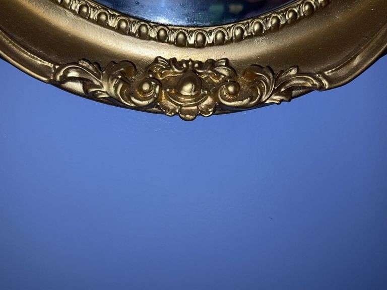Oval mirror in gold colored frame