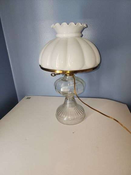 Vintage oil lamp witg milk glass lamp shade with a ruffled edge.
