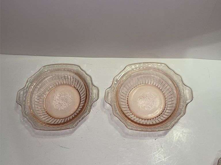 Pink depression glass serving bowl with a lid.