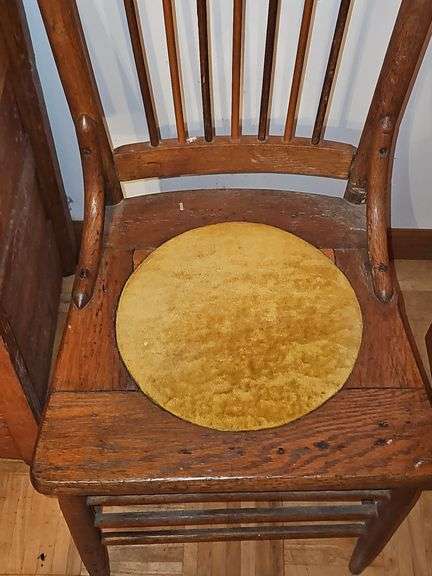 Antique spindle back chair with velvet yellow insert.