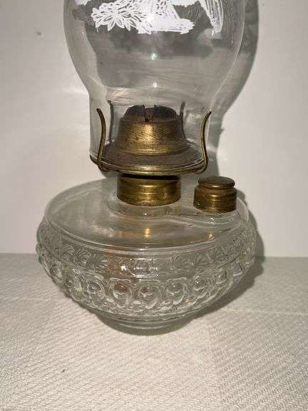 Clear glass oil lamp with chimney that has a Eagle on it