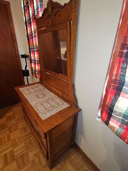 Antique American Eastlake three-drawer oak dresser with a carved mirror