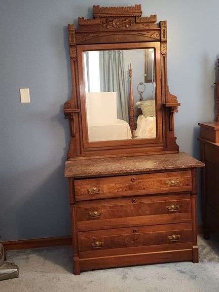 Victorian Eastlake walnut dresser with a marble top and a mirror.