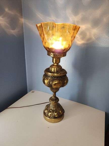 Vintage-style brass parlor lamp with amber colored shade