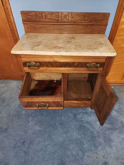 Vintage walnut washstand with a marble top.