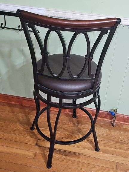 2 Black metal swivel bar stool with a dark brown cushioned seat.