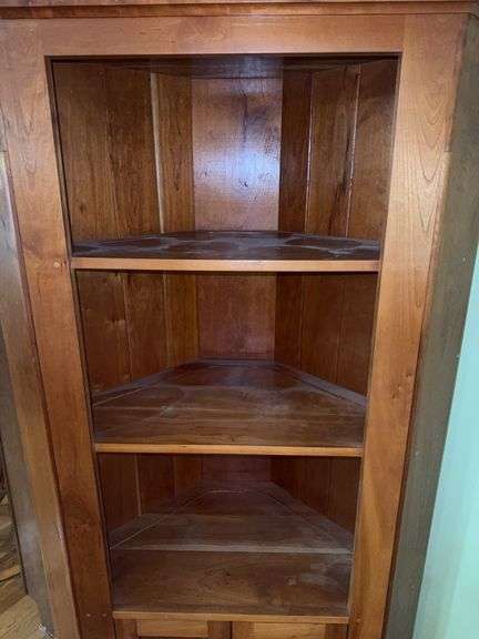 Wooden corner cabinet with display shelves and a lower storage cupboard