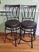 2 Black metal swivel bar stool with a dark brown cushioned seat.