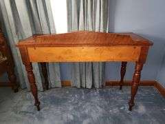 Vintage wooden side table with double drawers and turned legs.
