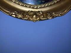 Oval mirror in gold colored frame