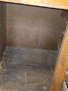 Solid oak gun cabinet with glass doors and a lower storage area with drawers