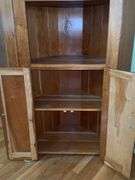 Wooden corner cabinet with display shelves and a lower storage cupboard