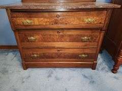 Victorian Eastlake walnut dresser with a marble top and a mirror.