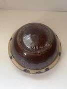 Vintage stoneware mixing bowl with a brown glaze and picket fence design. USA 9n the bottom