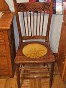 Antique spindle back chair with velvet yellow insert.