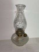 Clear glass oil lamp with chimney that has a Eagle on it