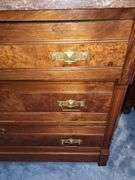 Victorian Eastlake walnut dresser with a marble top and a mirror.