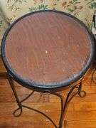 Vintage ice cream parlor stool with a twisted metal base and a round wooden seat.
