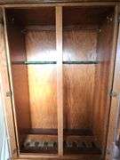 Solid oak gun cabinet with glass doors and a lower storage area with drawers