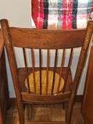 Antique spindle back chair with velvet yellow insert.