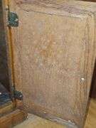 Solid oak gun cabinet with glass doors and a lower storage area with drawers