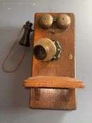 Antique wooden wall-mounted telephone