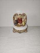 Framed print of Jesus, musical figurine, praying hands, & shelf.