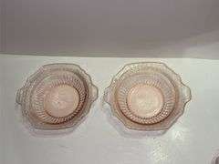 Pink depression glass serving bowl with a lid.