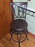 2 Black metal swivel bar stool with a dark brown cushioned seat.