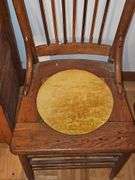 Antique spindle back chair with velvet yellow insert.