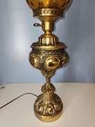 Vintage-style brass parlor lamp with amber colored shade