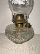 Clear glass oil lamp with chimney that has a Eagle on it