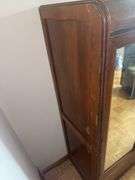 Wooden armoire with a mirrored door