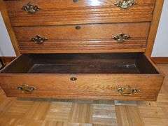 Antique American Eastlake three-drawer oak dresser with a carved mirror