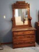 Victorian Eastlake walnut dresser with a marble top and a mirror.