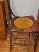 Antique spindle back chair with velvet yellow insert.