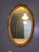 Oval mirror in gold colored frame