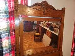 Antique American Eastlake three-drawer oak dresser with a carved mirror