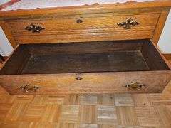 Antique American Eastlake three-drawer oak dresser with a carved mirror