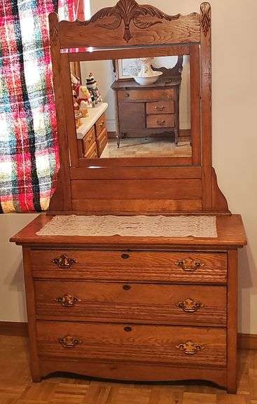 Antique American Eastlake three-drawer oak dresser with a carved mirror